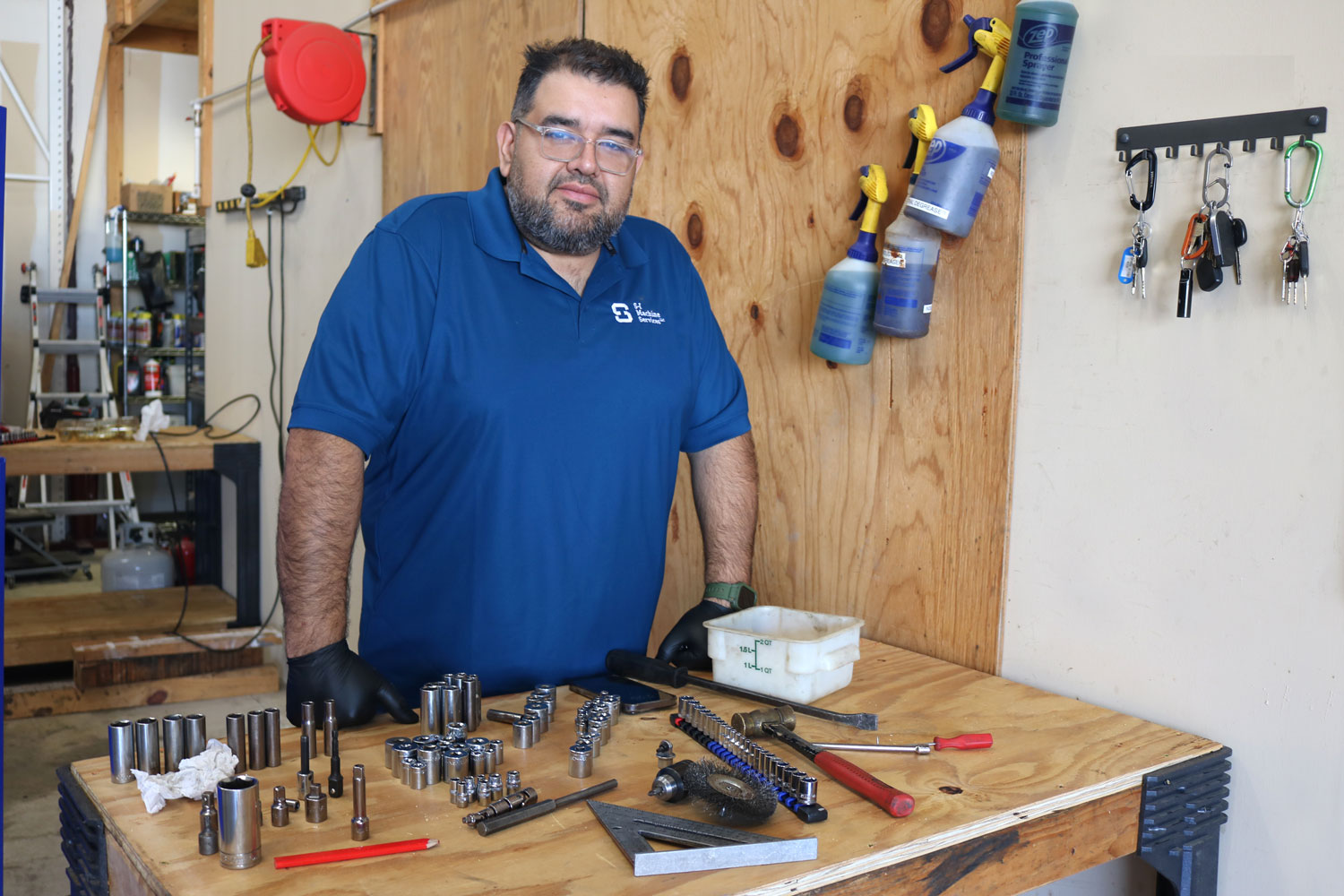 S I Machine Services staff with band saw equipment